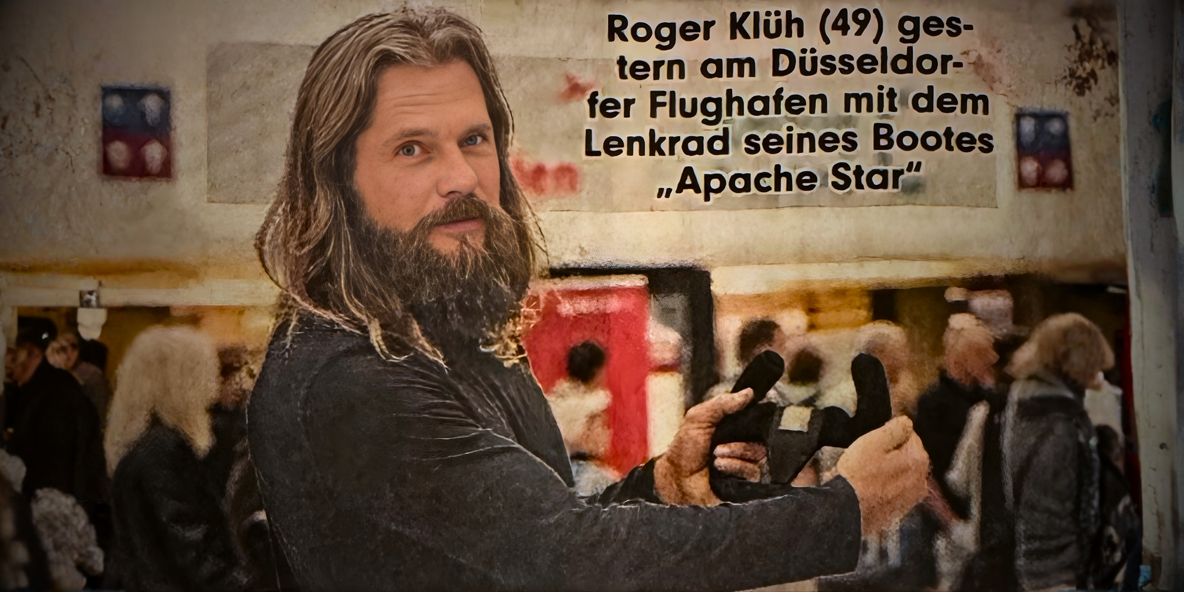 Roger Klüh holds original World Record Apache Star steering wheel at Düsseldorf Airport.