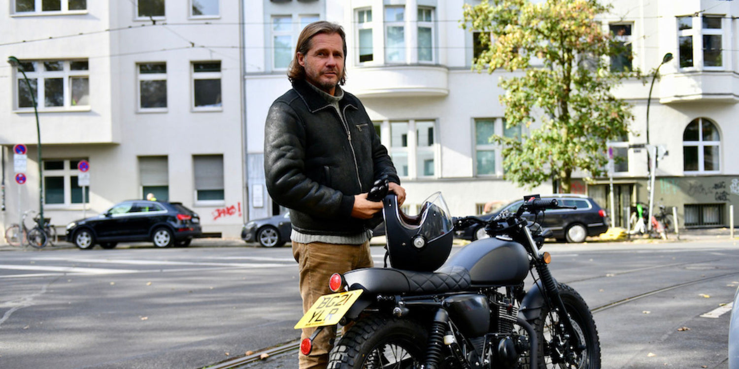 Roger Anthony Cassius Klüh dressed in APACHE STAR with his motorbike in Düsseldorf.