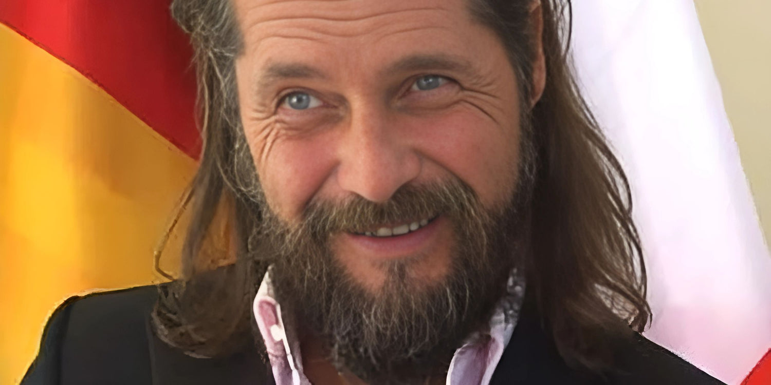 Roger Anthony Cassius Klüh in front of a German flag