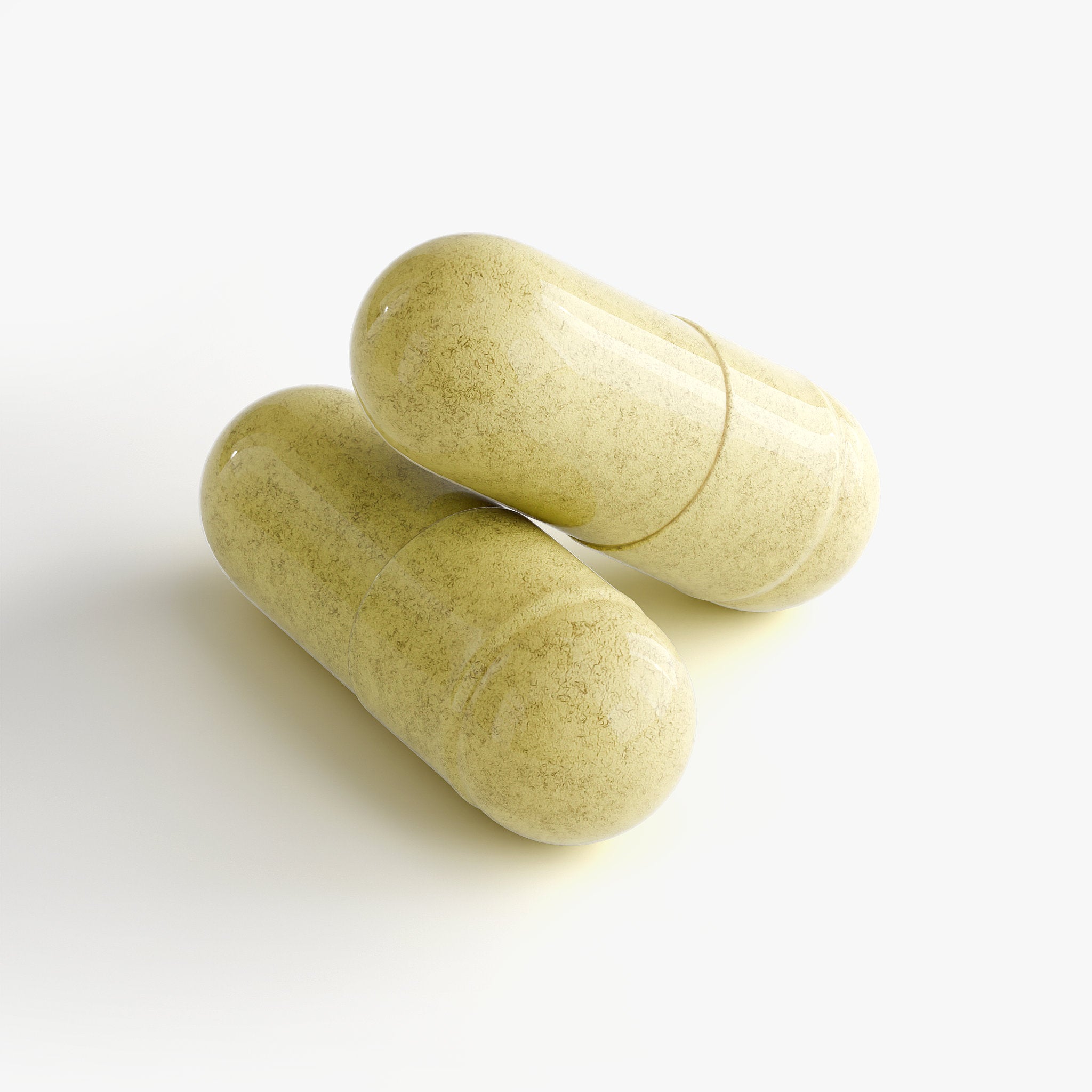 close-up of yellow capsules spilling from white supplement bottle