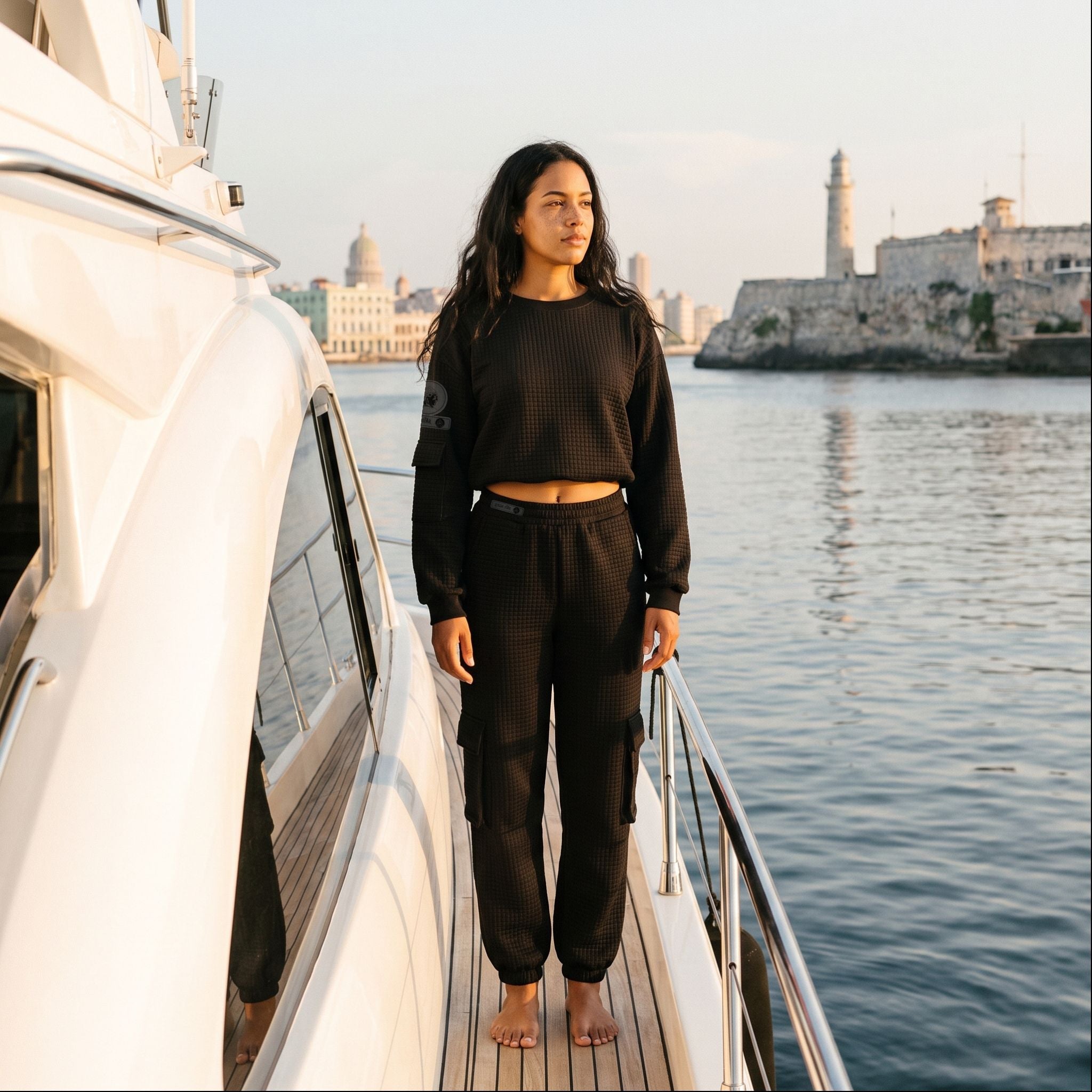 Model wearing the APACHE STAR® Havana waffle cargo set in Black at the Havana waterfront