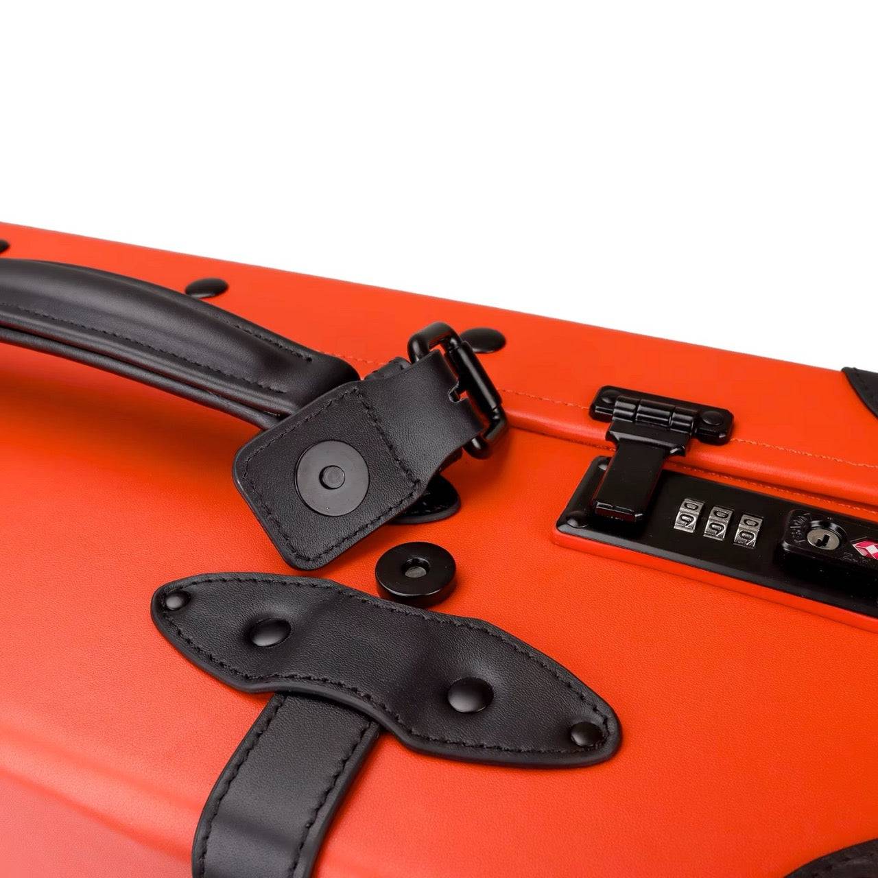 Close-up of APACHE STAR® Luxury Vintage Trunk Luggage in Signature Orange showing TSA lock, leather handle, and black strap detailing.
