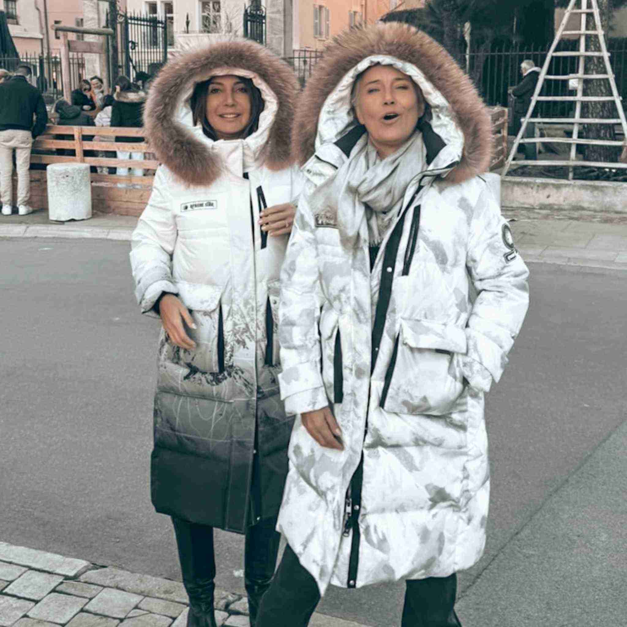 Two women wearing Trident Trooper Down Coats by APACHE STAR in St. Tropez, showcasing fashionable and functional winter outerwear.