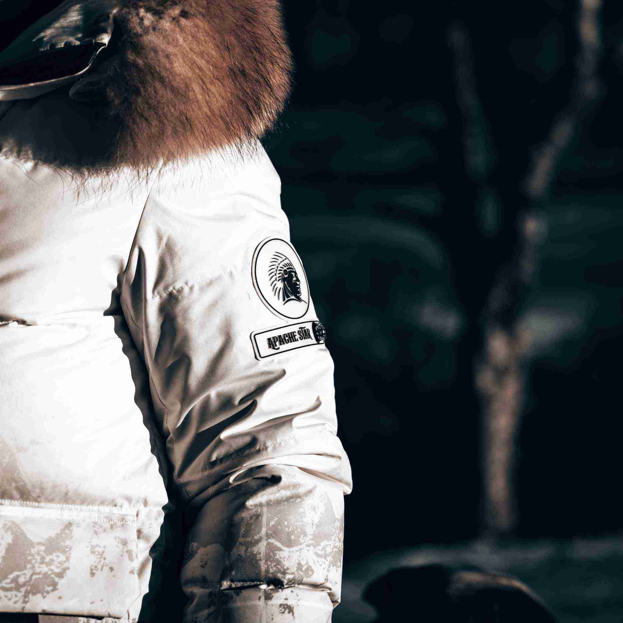 Close-up of Trident Trooper Down Coat sleeve with APACHE STAR logo, highlighting premium craftsmanship and winter durability.