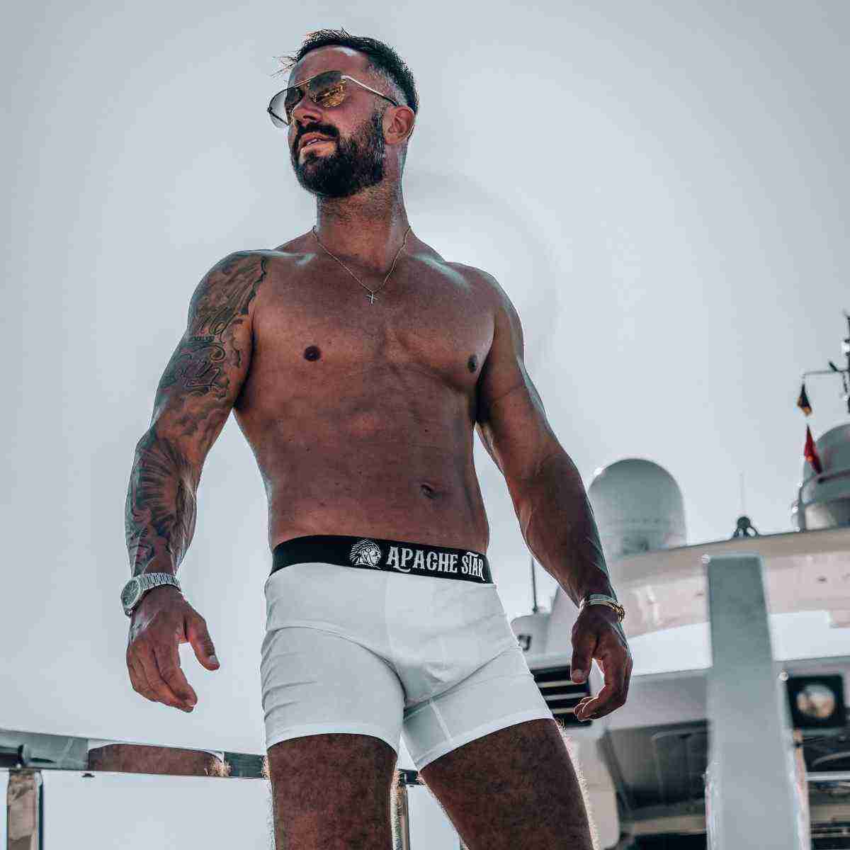 COMMANDER'S COMFORT - 3 or 5 pack Men's Boxer Briefs in white by APACHE STAR, modeled on a yacht showcasing luxury and comfort fit.