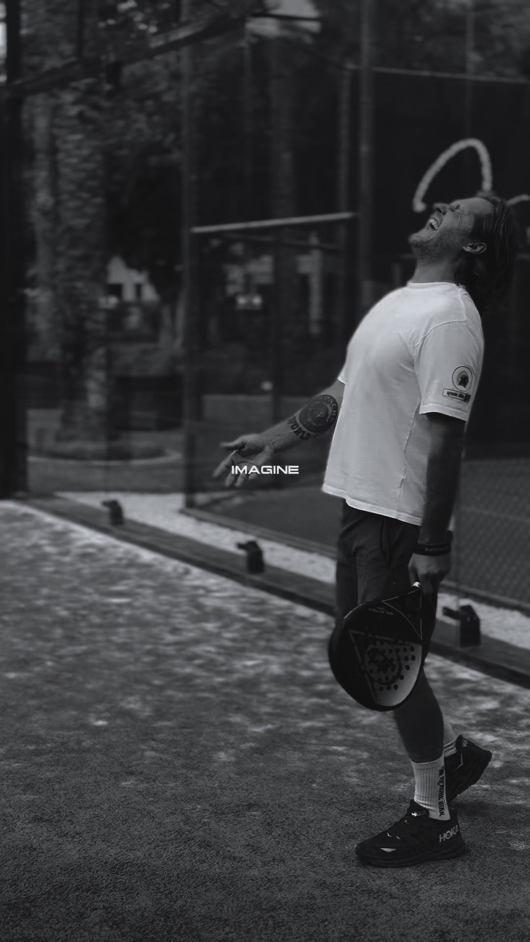 Roger Klüh playing paddle tennis in white Iconic APACHE STAR Miami Tee, highlighting performance-ready cooling and comfort.