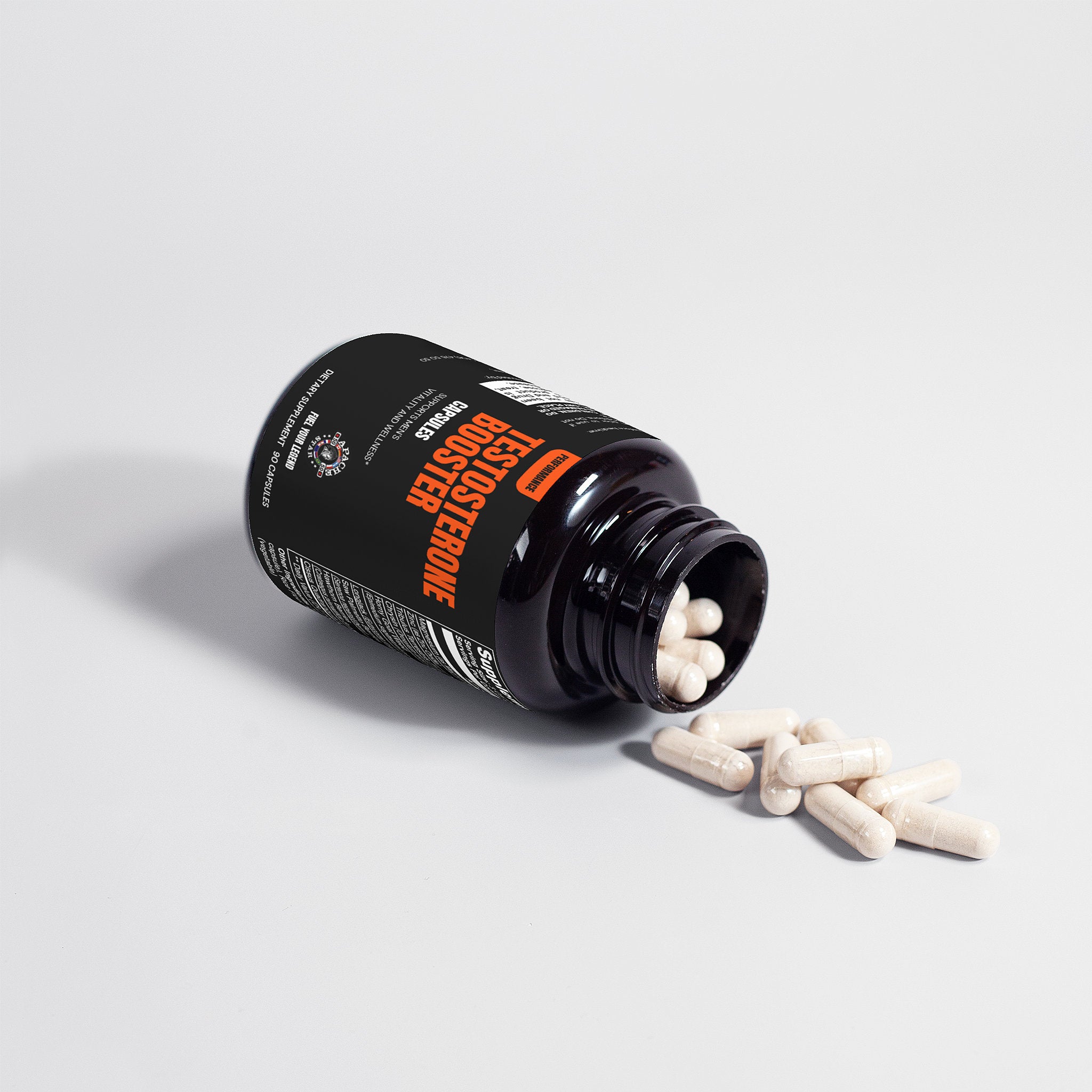 Testosterone booster supplement bottle with pills on white surface