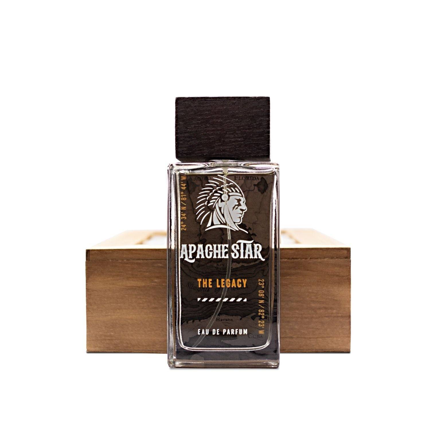 APACHE STAR® The Legacy Eau de Parfum 100ml bottle placed in front of a wooden box, emphasizing its masculine woody-aromatic profile.