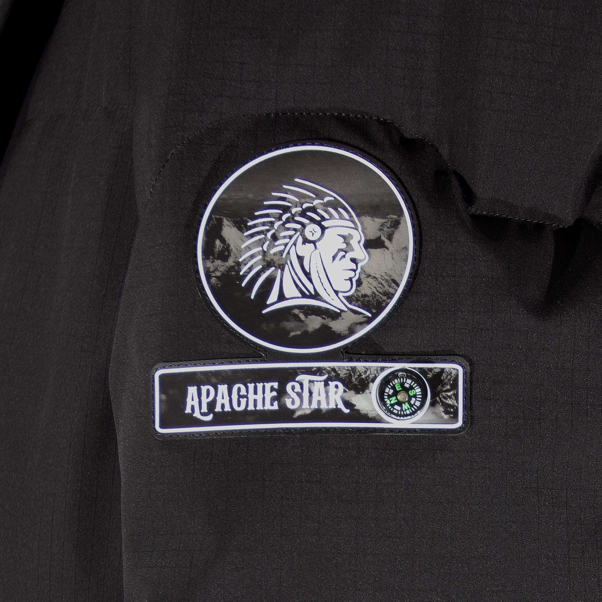 Close-up of APACHE STAR logo patch on the American Anchorage black down jacket, showcasing brand identity and compass detail.