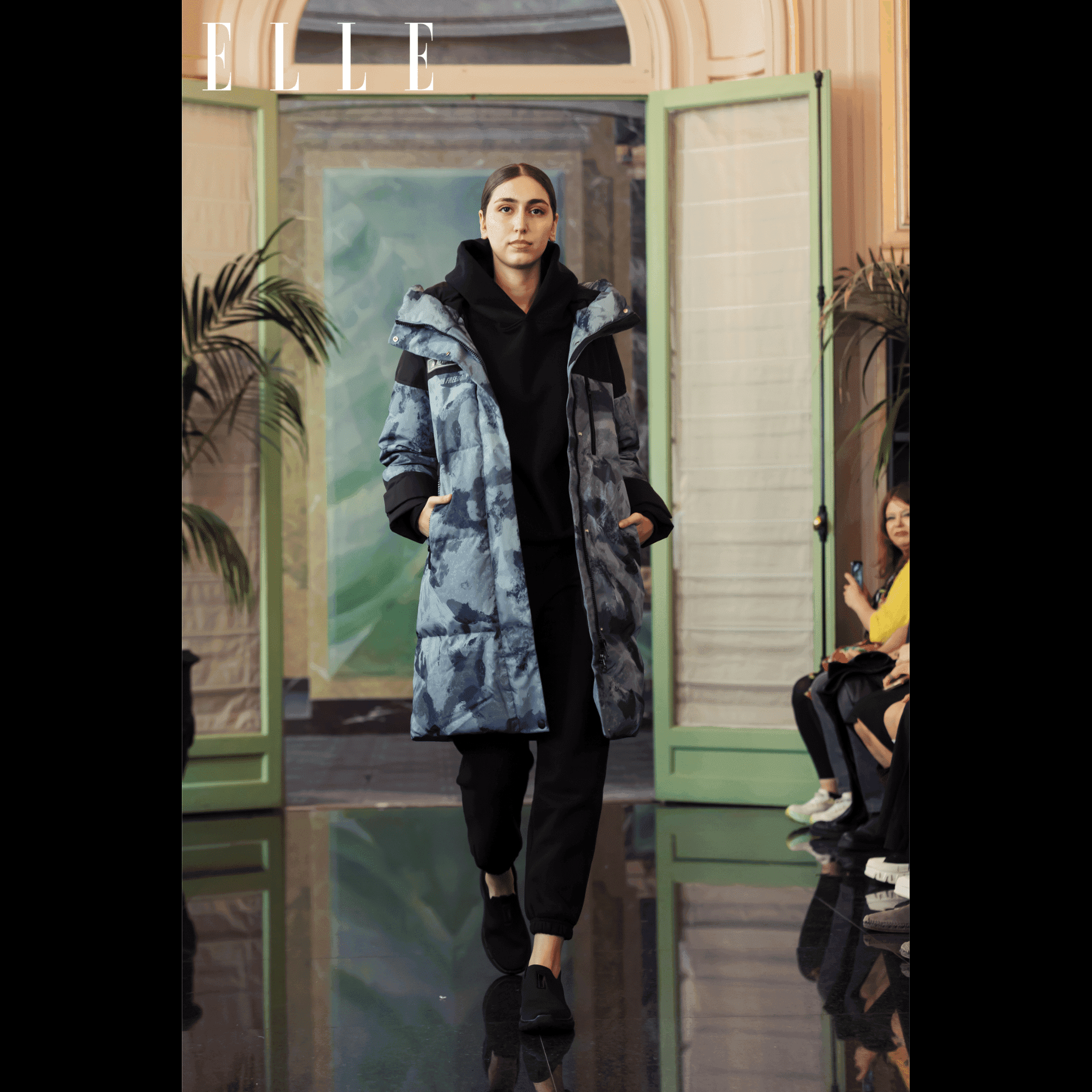 Vintage Down Coat - Blue Camouflage by APACHE STAR | Function, Style, Tech. Model walking runway in blue camouflage down coat at Paris Fashion Week featured in print magazine Elle, styled with black hoodie and pants.