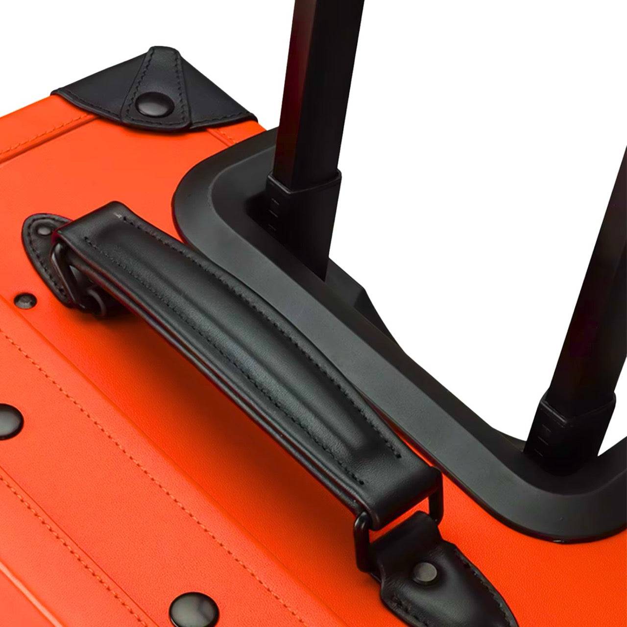 Top handle and telescopic pull handle of APACHE STAR® Signature Orange suitcase, showcasing ergonomic design and luxury genuine leather finish.