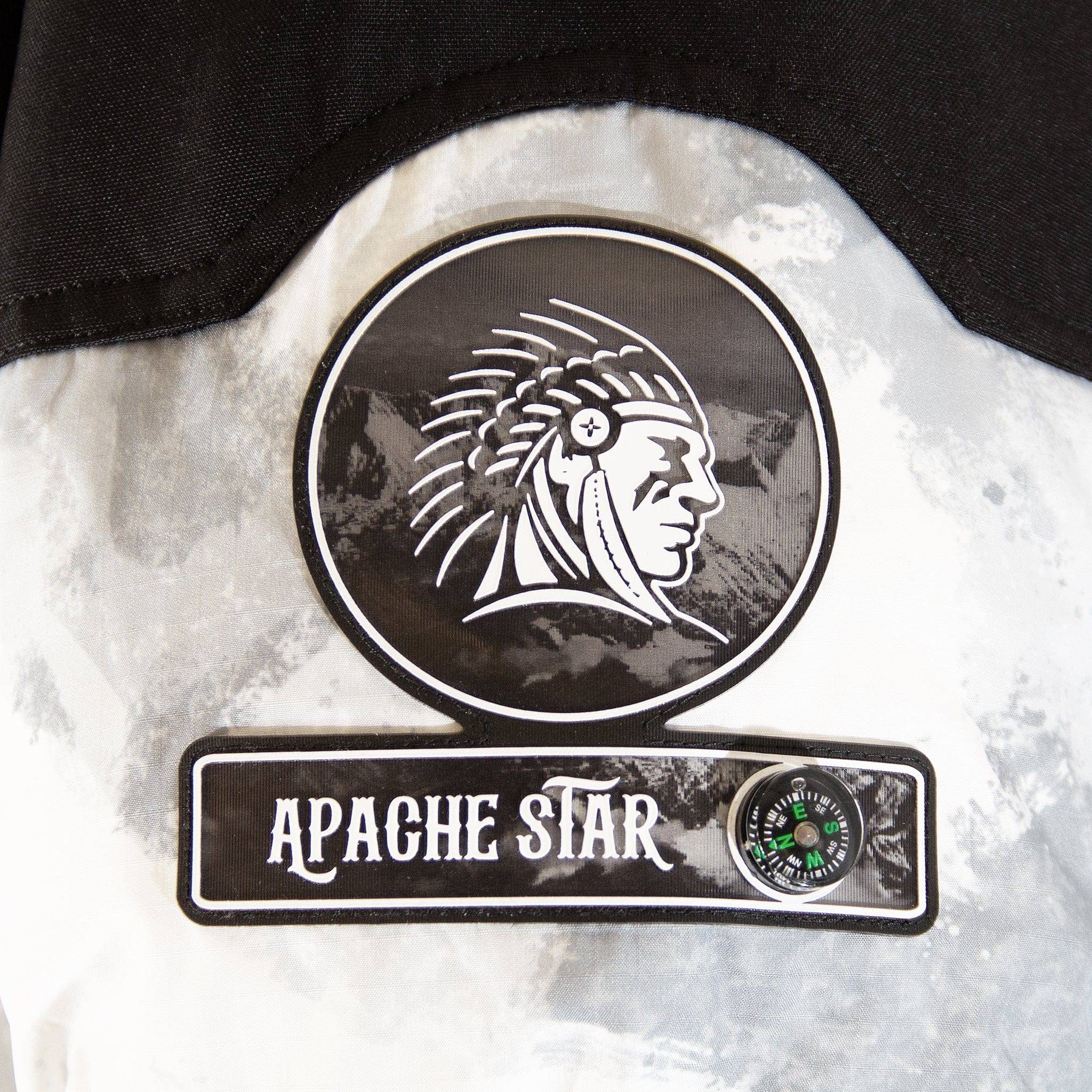 Close-up of APACHE STAR logo patch with compass detail on Submerged Sentry white down coat, highlighting brand identity and design elements.