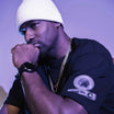 Man wearing white beanie and black Apache Star t-shirt with gold jewelry