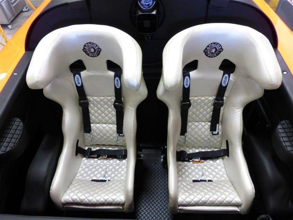 Two white quilted racing bucket seats in the cockpit of APACHE STAR