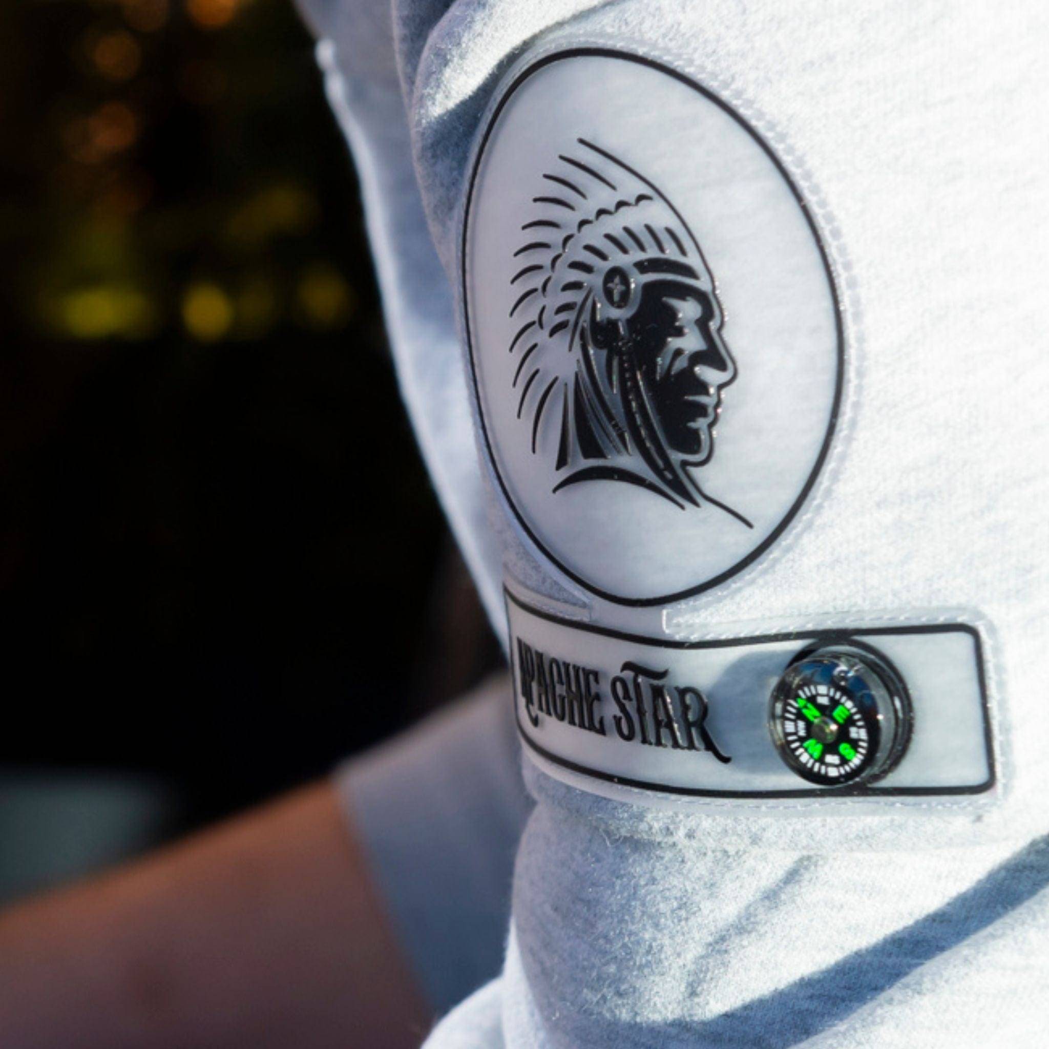 Detailed view of Monaco Sweatshirt in grey by APACHE STAR. Features signature compass and tribal emblem on sleeve patch.