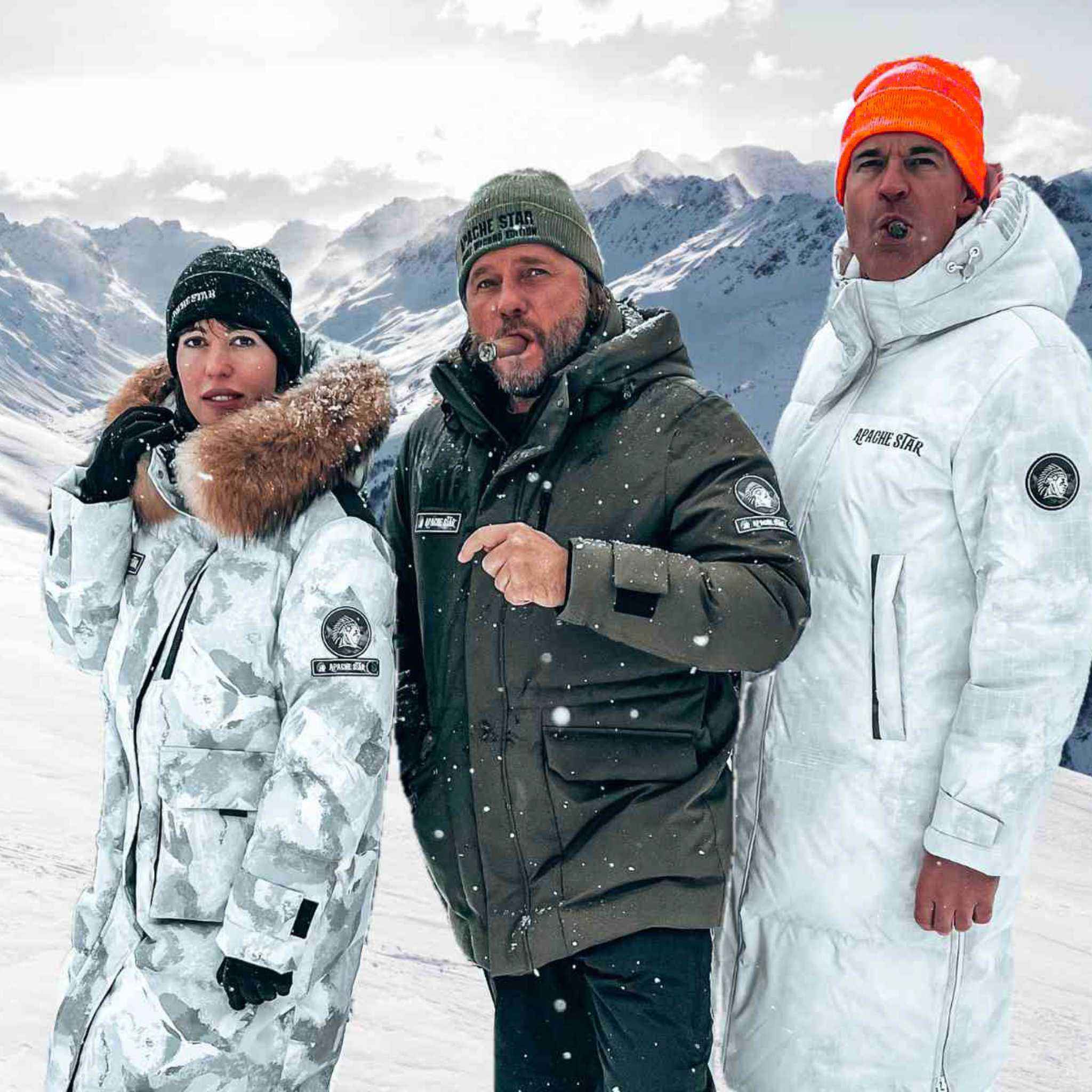 Group in snowy Kitzbühel mountains wearing APACHE STAR coats, including the white Brigade Breeze Down Coat, built for extreme weather.