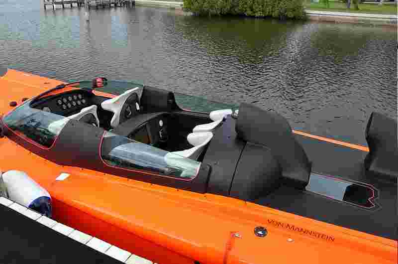 View into the cockpit of the orange powerboat APACHE STAR at the dock